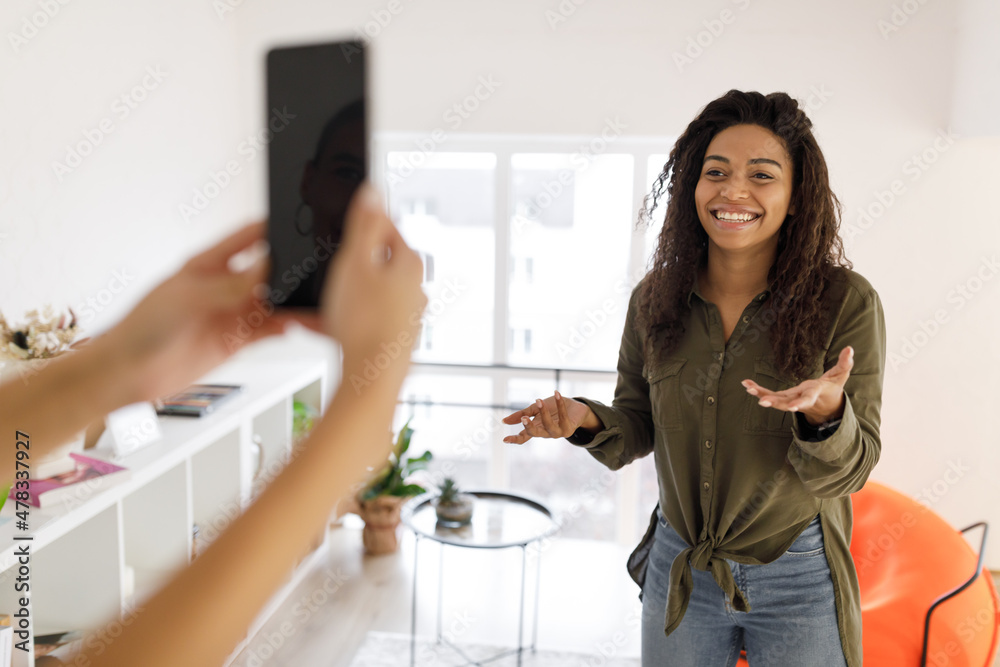 Cheerful black woman filming video on cellphone Cheerful black woman filming video on cellphone