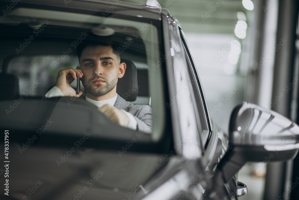 Handsome business man driving in car
