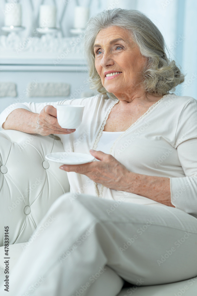 Close up portrait of beautiful smiling senior woman drinking tea Close up portrait of beautiful smiling senior woman drinking tea