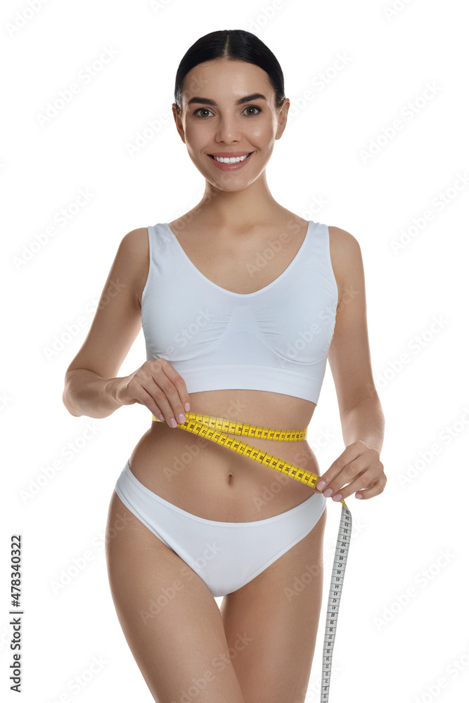 Young woman measuring waist with tape on white background Young woman measuring waist with tape on white background