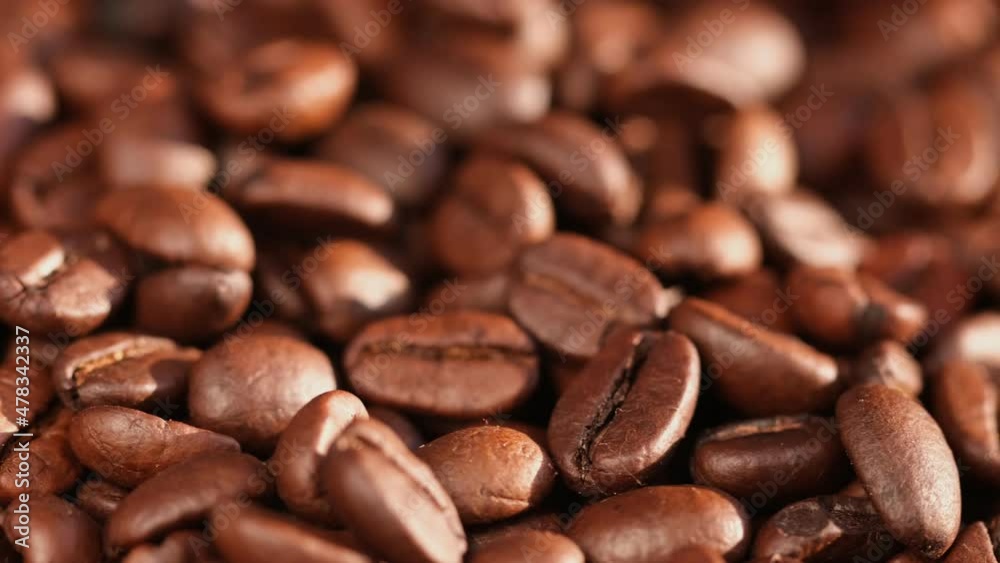 Close up of seeds of coffee. Fragrant coffee beans are rotate Close up of seeds of coffee. Fragrant coffee beans are rotate
