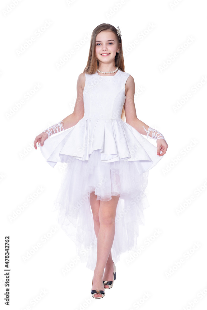 Happy beautiful little girl in white dress posing isolated