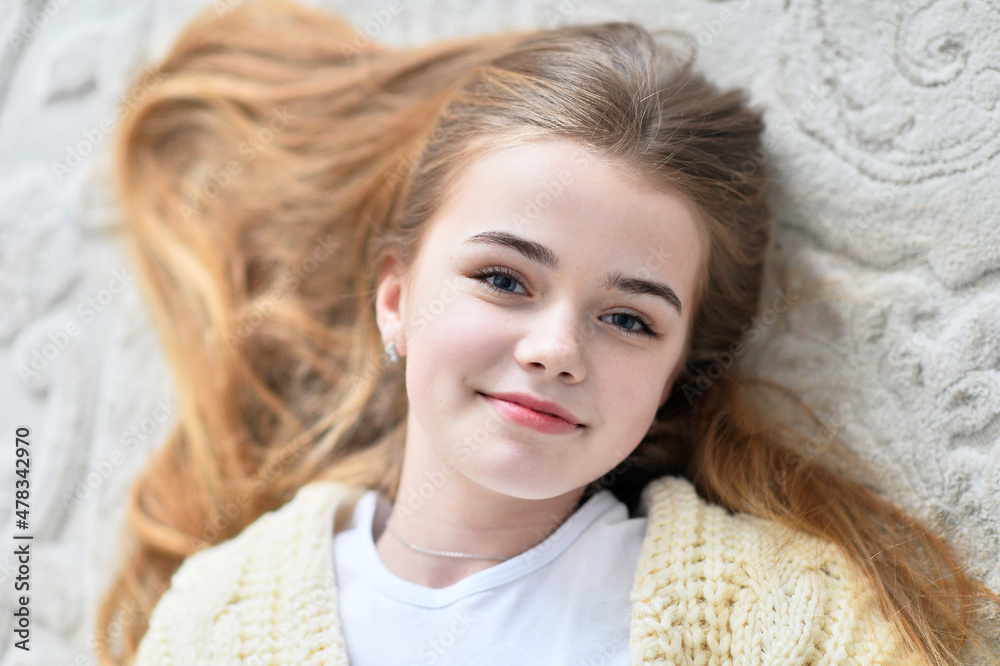 Portrait of beautiful teen girl lying on floor in room Portrait of beautiful teen girl lying on floor in room