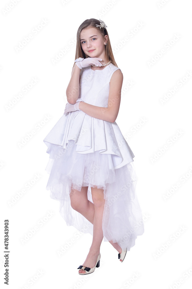 Happy beautiful little girl in white dress posing on white background Happy beautiful little girl in white dress posing on white background