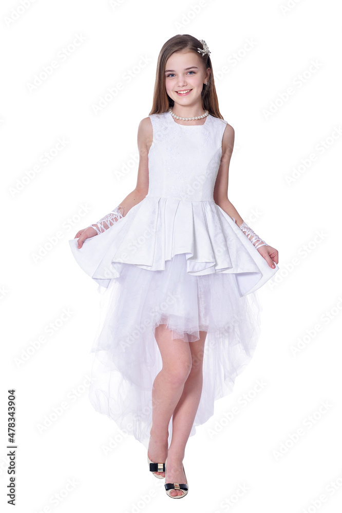 Happy beautiful little girl in white dress posing on white background Happy beautiful little girl in white dress posing on white background