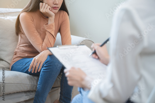Young woman in a mental therapy session talking with a psychologist in the office. photo