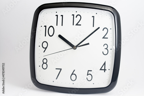 Black classic clock on isolated white background.