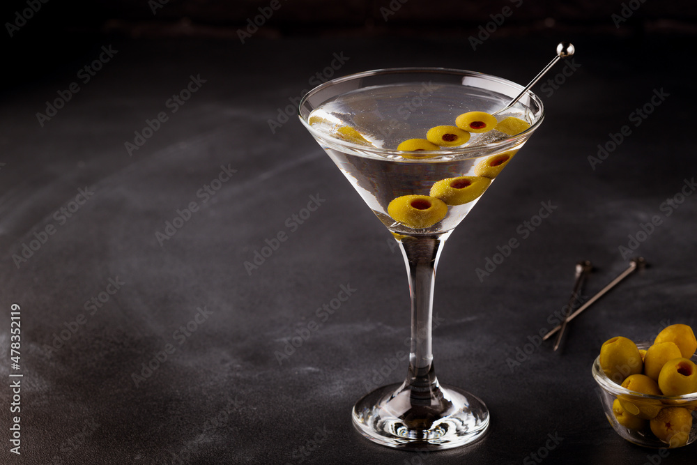 Martini cocktail on dark stone table.