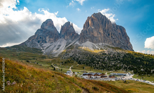 Sunset light panorama of Mountain Resort under Langkofel Group, Grohmannspitze mountain, Fuenffingerspitze mountain and Langkofel Mountain, Sella Pass, Dolomites, Alto Adige, Italy