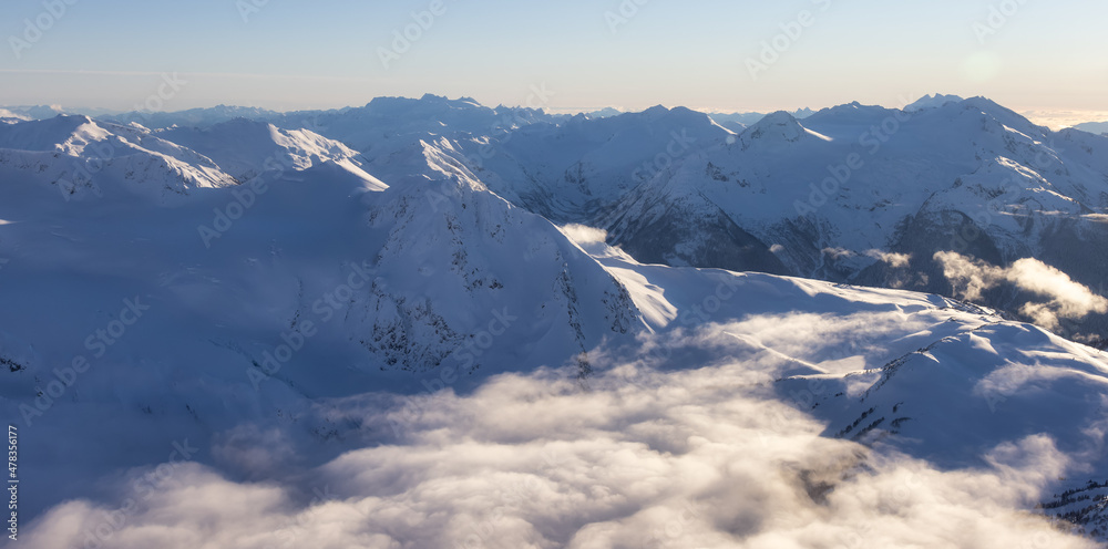 Aerial Panoramic View of Canadian Mountain covered in snow during sunny winter season. Located near Whistler, North of Vancouver, British Columbia, Canada. Nature Background Panorama