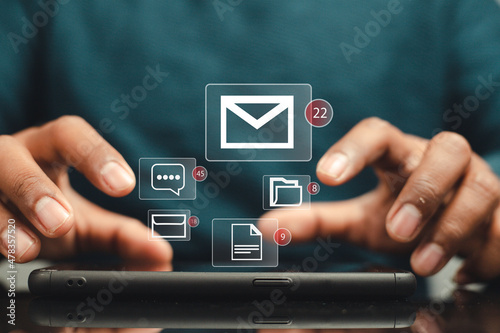 Businessman using smartphone to check email notification with icon or hologram. online communication technology concept
