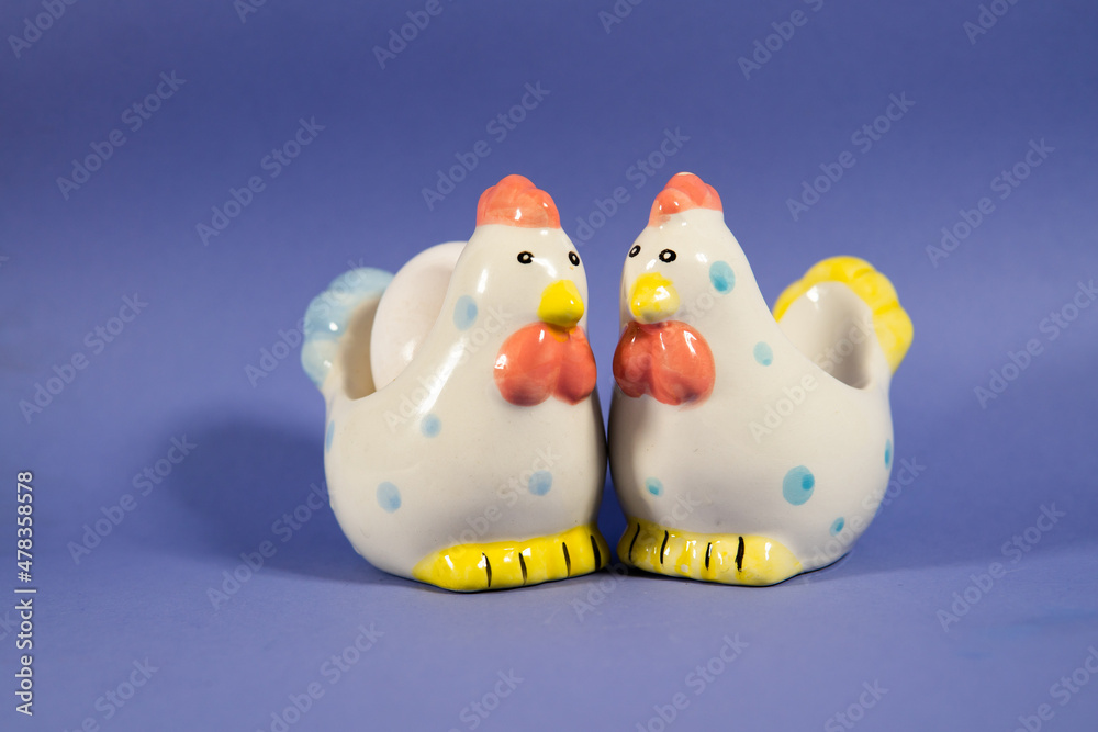ceramic chicken on a purple background ceramic chicken on a purple background