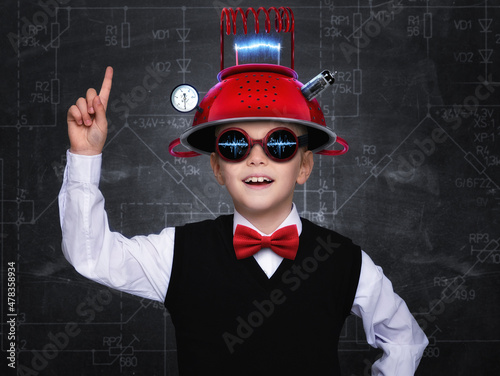 Smart child pretend to be inventor. Funny kid wearing helmet . Education, artificial intelligence and business idea concept