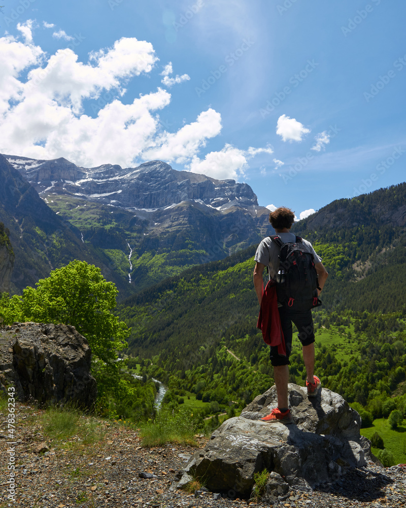vertical image of a mountaineer enjoying the landscape in front of him, in which he can see sky, mountains, waterfalls and rivers, vertical image of a mountaineer enjoying the landscape in front of him, in which he can see sky, mountains, waterfalls and rivers,