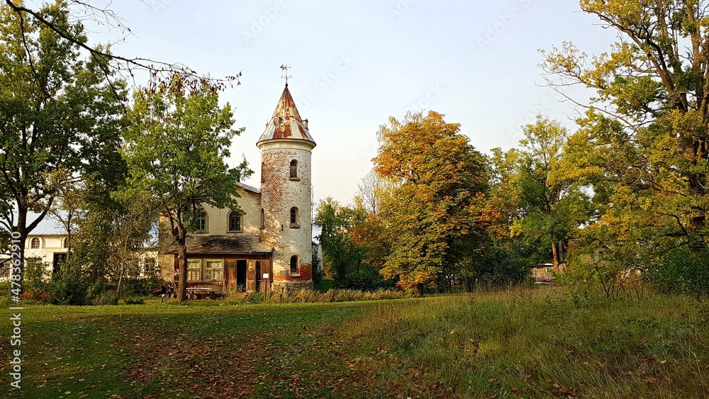 Small old house with a round tower in the Latvian village of Jaungulbene on October 2, 2020