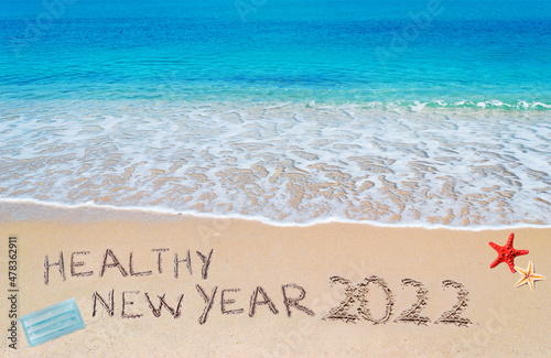 healthy new year 2022 written on the sand