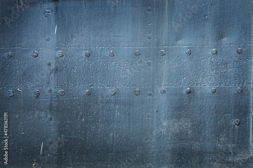 Metal texture with rivets from hull of old ship photo