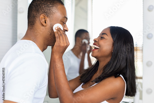 Home Skin Care. Cheerful Black Couple Having Fun In Bathroom