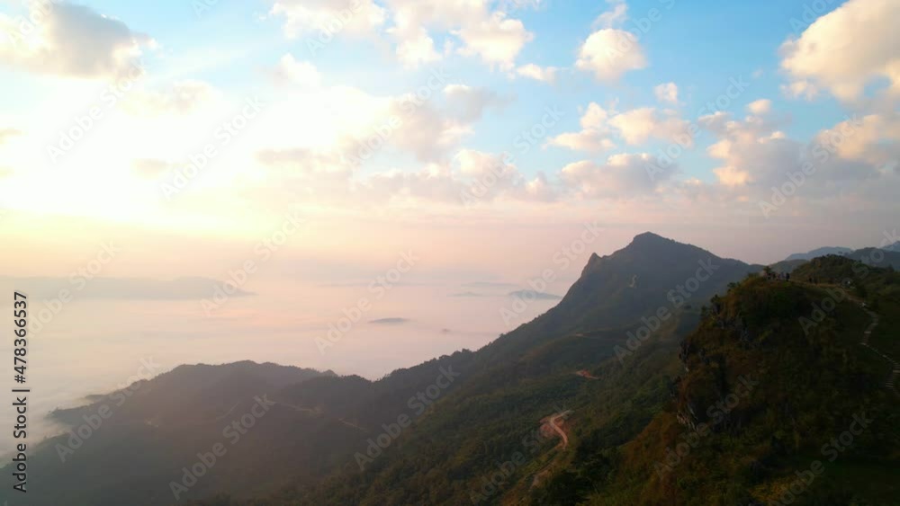 The rays of the sun shine through the clouds into the misty sea above the mountains in the morning. 4K aerial shot on sunrise
The rays of the sun shine through the clouds into the misty sea above the mountains in the morning. 4K aerial shot on sunrise