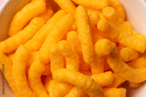Closeup of a bowl of cheese doodles.