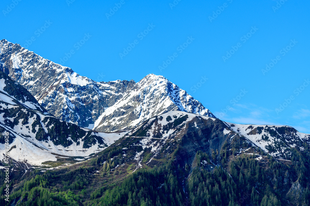 The snow capped Mont Lachat in the Mont Blanc massif in Europe, France, the Alps, towards Chamonix, in summer on a sunny day.