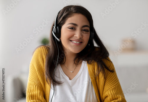 Operator of hot line. Portrait of friendly arab customer service representative wearing headset in call center