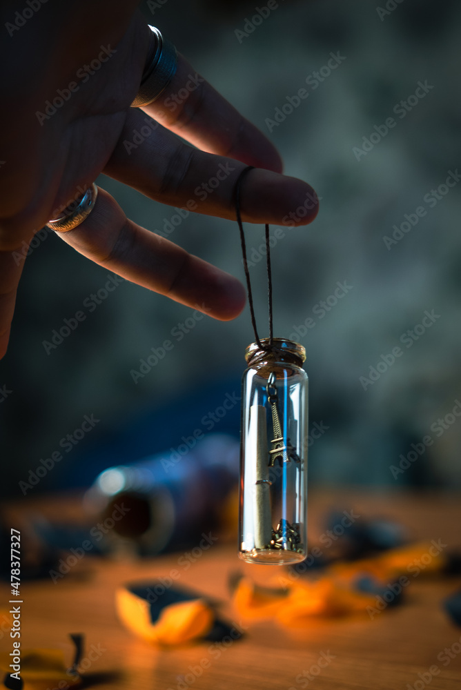 transparent pendant in hand a present for good luck on a dark background transparent pendant in hand a present for good luck on a dark background