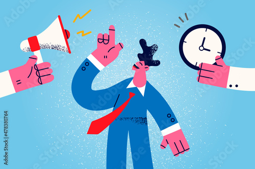 Smiling businessman with clock and megaphone meet deadline 