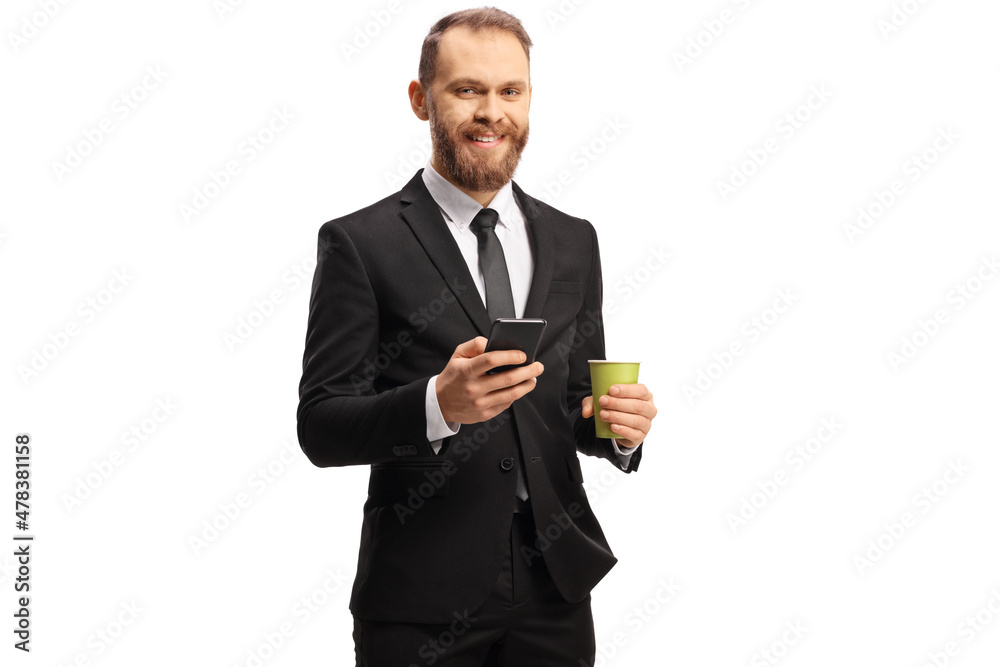 Young businessman holding a takeaway coffee cup and a smartphone Young businessman holding a takeaway coffee cup and a smartphone