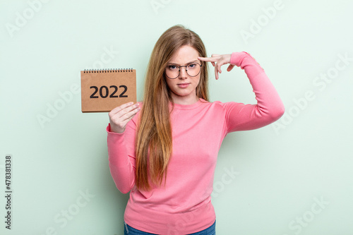 Carta da parati red head woman feeling confused and puzzled, showing you are insane agenda 2022