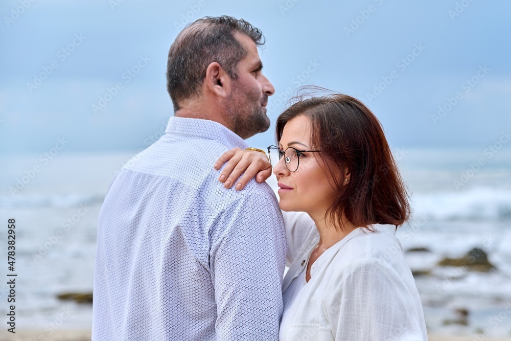 Outdoor portrait of mature couple hugging on the seashore Outdoor portrait of mature couple hugging on the seashore