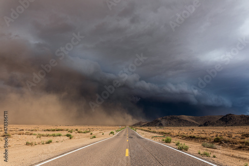 storm clouds over a road in the desert