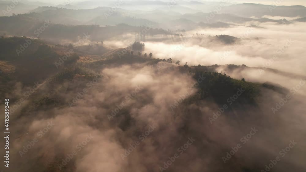 4K Aerial view from drone over mountains and sea of fog. Golden scenery at sunrise 4K Aerial view from drone over mountains and sea of fog. Golden scenery at sunrise