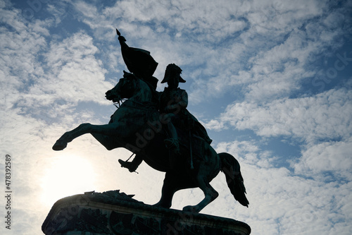silhouette of a knight against dark blue sky, heldenplatz Vienna. With dramatic clouds in the background and enough space for text. photo
