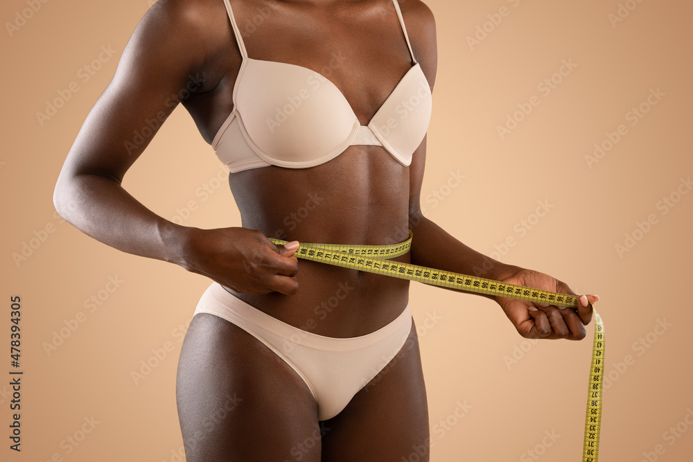 Foto Stock Young skinny female in underwear measuring her perfect waist |  Adobe Stock