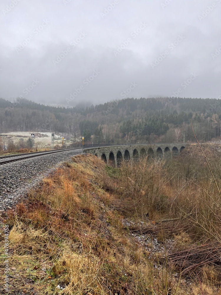 vintage stone railway bridge in autumn day