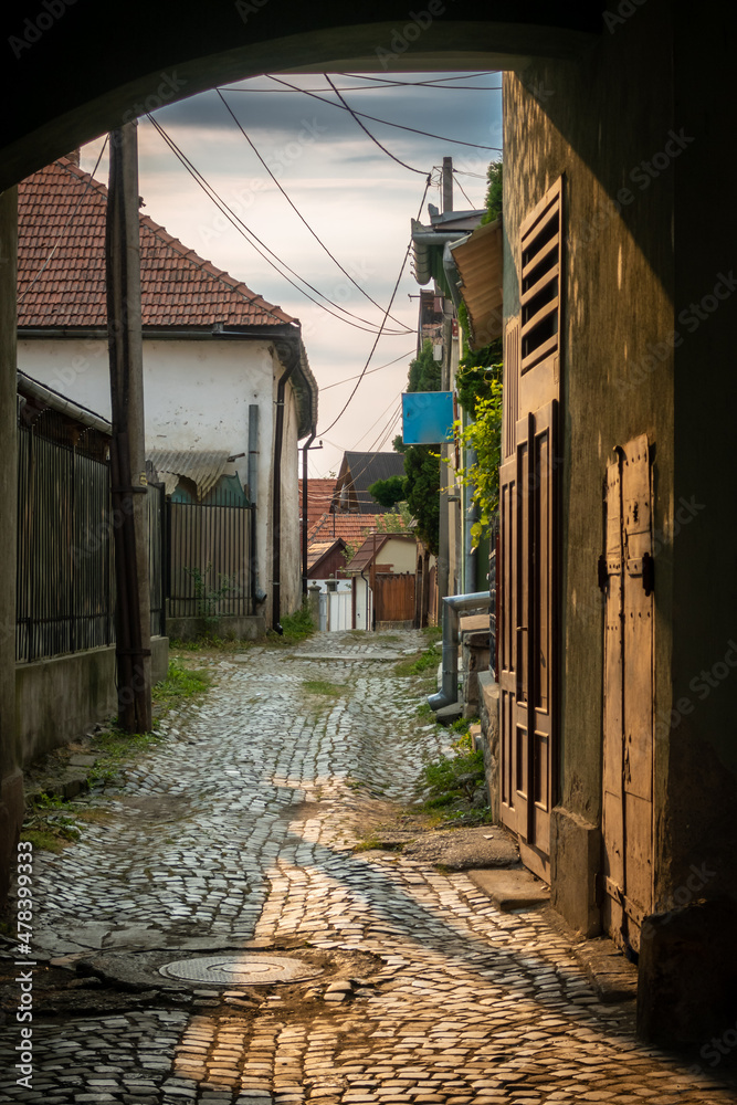 Back street with cobble stones in small town in Romania