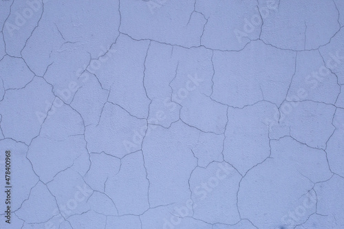 Old retro scratched cracked white grey light blue painted plaster stucco wall background texture.
