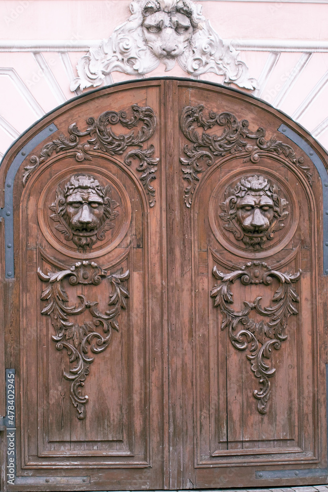 rusty metal antique lion's head doorknocker on a gray stone wall. High quality photo rusty metal antique lion's head doorknocker on a gray stone wall. High quality photo
