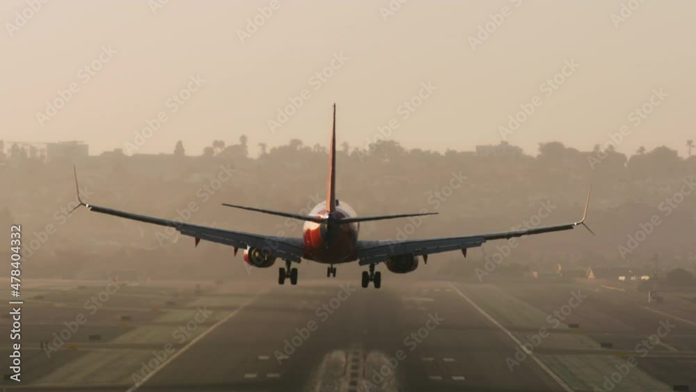 Huge passenger aircraft uses chassis for landing along an airport runway during beautiful sunrise. Scenic view of an airliner arriving. High quality 4k footage Huge passenger aircraft uses chassis for landing along an airport runway during beautiful sunrise. Scenic view of an airliner arriving. High quality 4k footage
