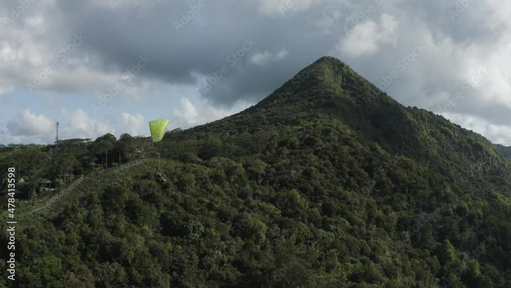 Aerial view of a person doing paragliding among the mountain, Mauritius. Aerial view of a person doing paragliding among the mountain, Mauritius.