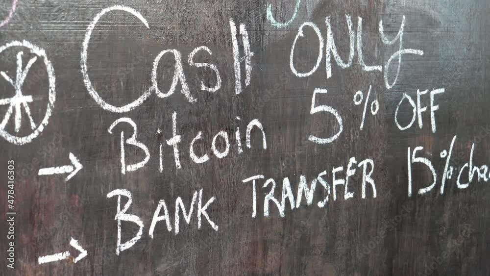 Full shot, a wooden board with a written sign of bitcoin cash only and discount in the bitcoin beach in el Salvador Mexico.