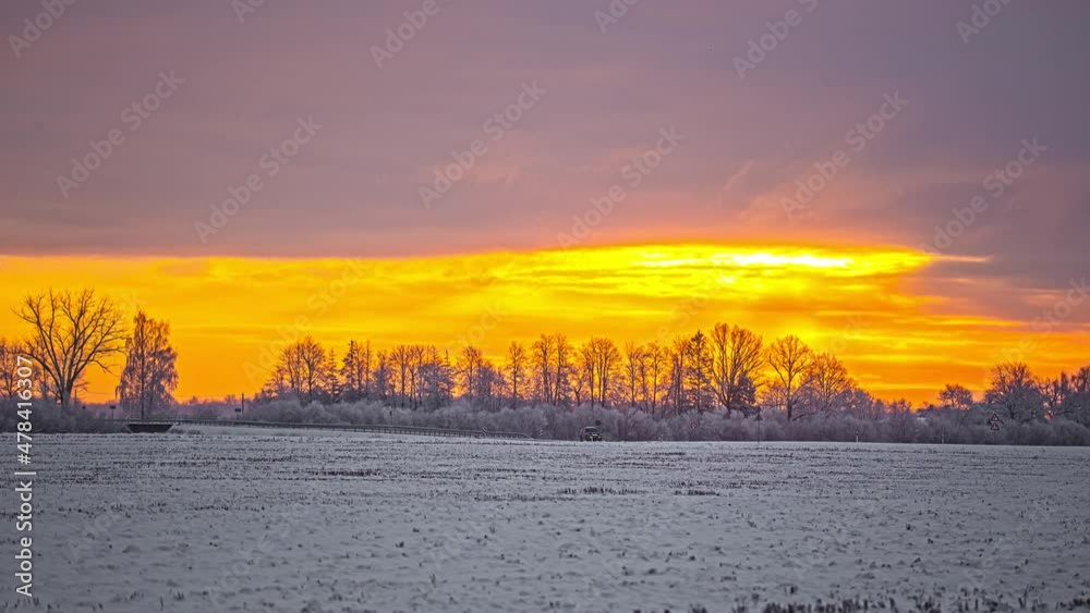 Snowy yellow time lapse scene, outdoor static shot of a winter forest scenery 