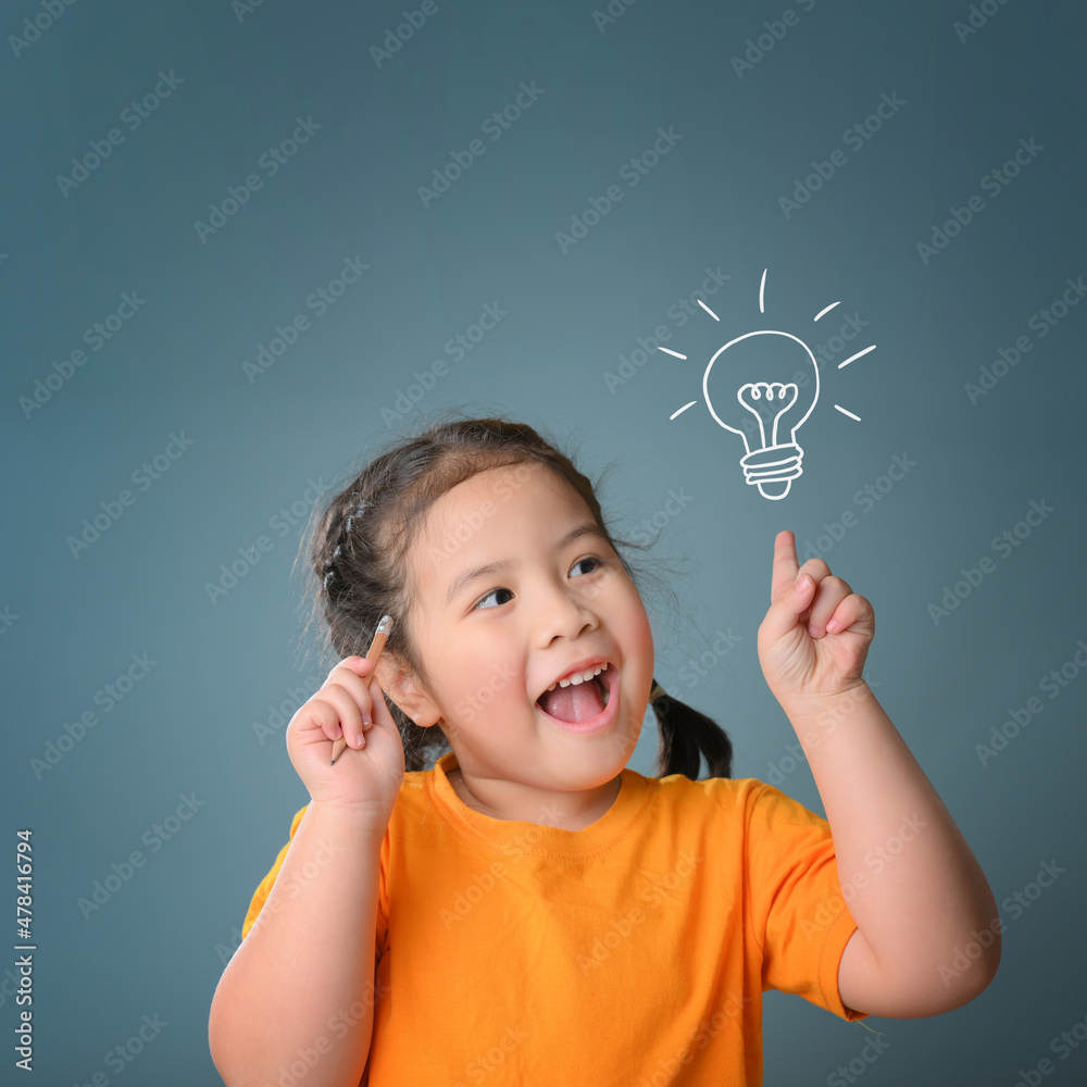Thinking a cute little child girl on blue background with light bulb. Child thinking. Brainstorming and idea concept. Education concept. Thinking a cute little child girl on blue background with light bulb. Child thinking. Brainstorming and idea concept. Education concept.
