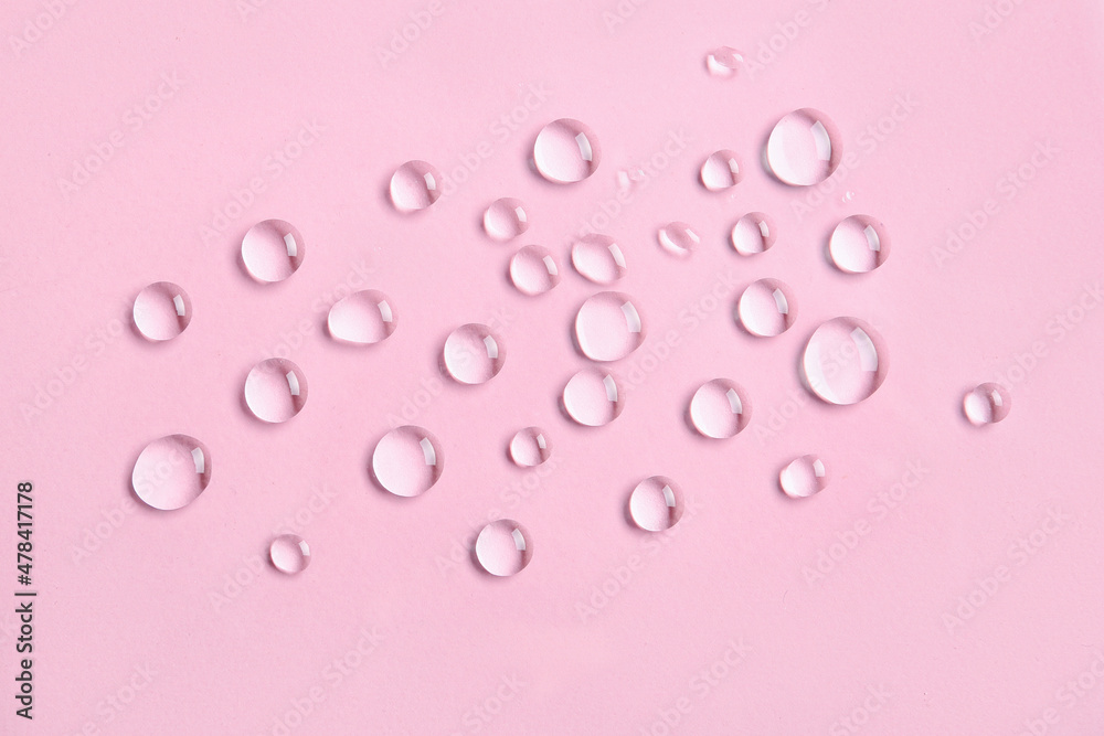 Many water drops on pink background