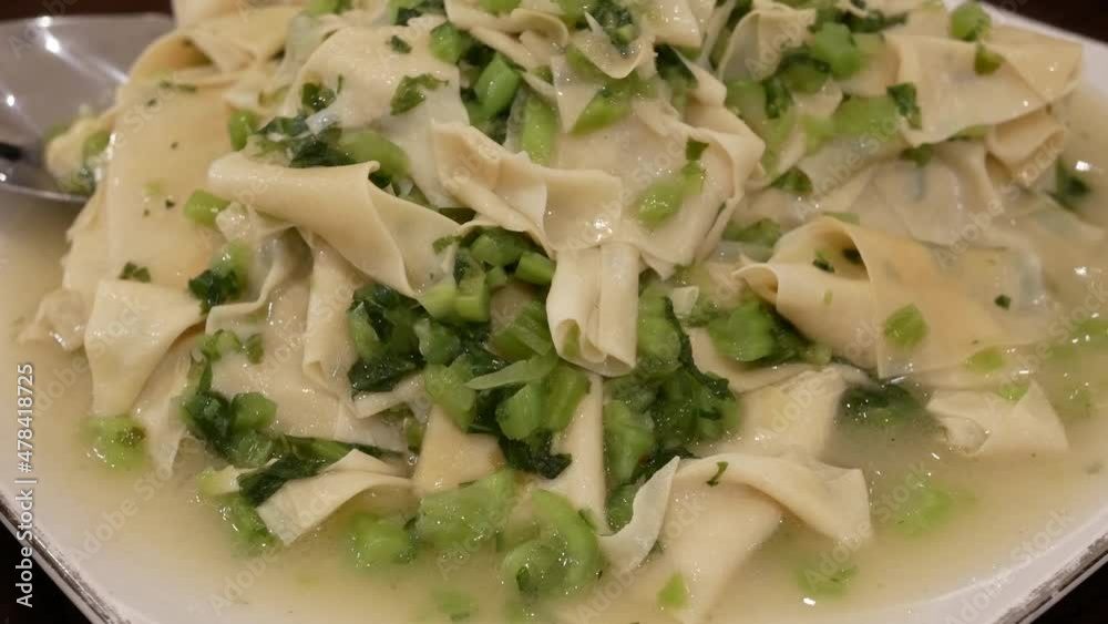 The motion of Stir-fried vegetables with tofu skin on a plate with steam inside Chinese restaurant 4k resolution.
