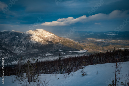 Sunbeam over isolated Dufour mountain at sunset, Charlevoix, QC, Canada