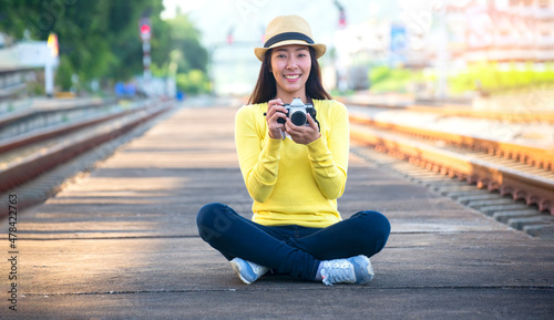 young asian woman smilingTraveler girl walking and waits train on railway platform