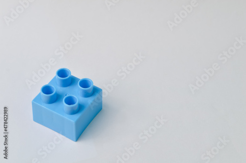 Blue toy building block isolated on a white background