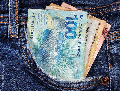 money notes of 50 reais 100 reais and 200 reais from brazil in jeans pocket. space for text. money from brazil. earn money. Real, Currency, Money, Dinheiro, Reais, Brasil. photo